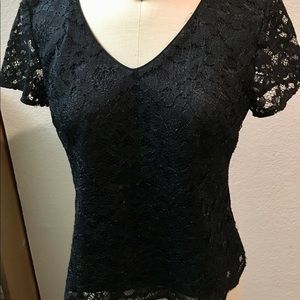 Black lined lace top with short sleeves.